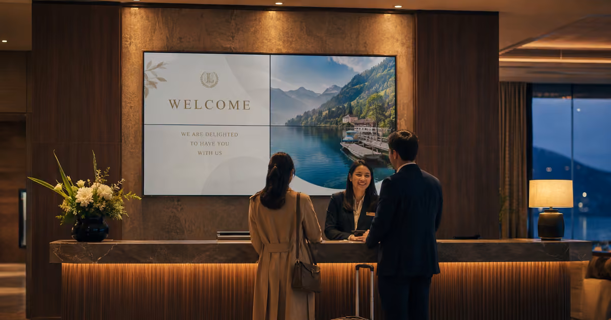 Hotel reception with a large welcome and guest-information display.